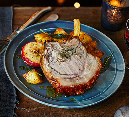 Roast pork with sage & double onion stuffing, baked apples & roasties