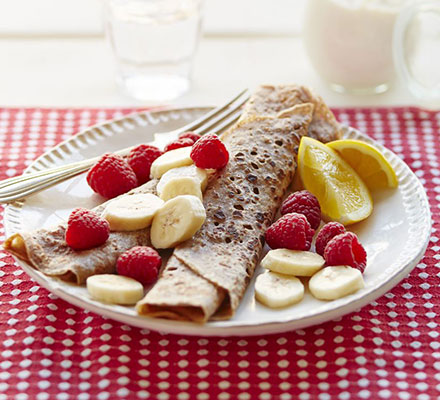 Cinnamon crêpes with nut butter, sliced banana & raspberries