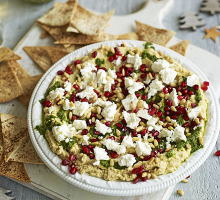 Layered hummus with spiced tortilla chips