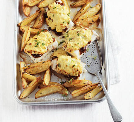 Cheese & onion rarebit-topped pollock with potato wedges